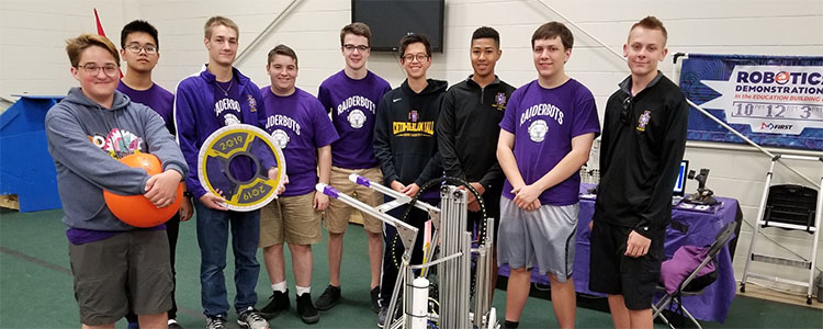 The team at the start of the day, prior to demonstrations, with the robot from the 2018-2019 season. Left to right: Seamus Dougherty '22, Xuan An Le '21, Andrew Domler '21, Liam O'Connor '21, Christian Strommen '20, Connor Lee '21, Ian Machado '20, Thomas Cunningham '20, Daniel Umland '22.